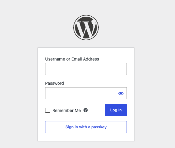 The WordPress login form with the "Sign in with a passkey" button.